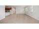 Open-concept living area with tile flooring, bright windows and access to the kitchen at 2477 Water Willow Dr, Lutz, FL 33558