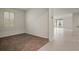Carpeted living room with a bright window and tile flooring leading into an adjacent space at 2477 Water Willow Dr, Lutz, FL 33558