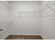 Walk-in closet with carpeted floor, white trim, and adjustable metal shelving at 2477 Water Willow Dr, Lutz, FL 33558