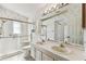 Well-lit bathroom featuring a double sink vanity, shower, and floral wallpaper at 254 Timberview Dr, Safety Harbor, FL 34695
