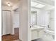 Bright bathroom features a single sink vanity, skylight and tiled shower and tub at 254 Timberview Dr, Safety Harbor, FL 34695