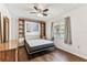 Bedroom with wood-look floors, neutral decor, built in storage, and a large window at 254 Timberview Dr, Safety Harbor, FL 34695