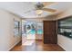 Bonus room features a ceiling fan, wood-look floors, a window, and glass doors leading to the pool at 254 Timberview Dr, Safety Harbor, FL 34695