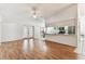 Bright living room with hardwood floors open to the eat-in kitchen at 254 Timberview Dr, Safety Harbor, FL 34695