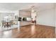 Open-concept living and dining area with hardwood floors and view of eat-in kitchen at 254 Timberview Dr, Safety Harbor, FL 34695