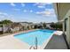 Sparkling pool with patio area, surrounded by white fencing and mature landscaping at 254 Timberview Dr, Safety Harbor, FL 34695