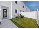 Private backyard with new fence, small green space, and modern exterior details at 3402 E 28Th Ave # 6, Tampa, FL 33605