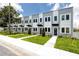 Street view of townhomes featuring a landscaped lawn and matching trees and shrubbery at 3402 E 28Th Ave # 6, Tampa, FL 33605