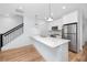 Kitchen featuring stainless steel appliances, quartz countertops, and modern white cabinetry with a staircase in view at 3402 E 28Th Ave # 6, Tampa, FL 33605