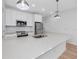 Modern kitchen featuring white cabinets, stainless steel appliances, and light backsplash at 3402 E 28Th Ave # 6, Tampa, FL 33605