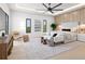 Bright and spacious main bedroom featuring stylish seating, chic decor, and ambient lighting at 3408 W Arch St, Tampa, FL 33607