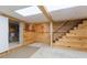 Wood paneled basement space with stairs and unfinished storage area at 34211 Blanton Rd, Dade City, FL 33523
