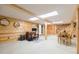 Office area in a wood paneled basement with desk, chair, and natural light at 34211 Blanton Rd, Dade City, FL 33523