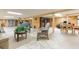 Spacious wood paneled basement with seating and table at 34211 Blanton Rd, Dade City, FL 33523