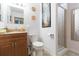 Bathroom featuring a granite vanity, toilet, and glass enclosed shower at 34211 Blanton Rd, Dade City, FL 33523