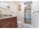 Bathroom featuring a modern vanity, granite countertop, toilet, and glass-enclosed shower at 34211 Blanton Rd, Dade City, FL 33523