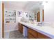 Bright bathroom featuring a long vanity with storage and a decorative shelving unit at 34211 Blanton Rd, Dade City, FL 33523