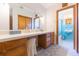 Bright bathroom featuring a long vanity with ample storage and an adjacent shower room at 34211 Blanton Rd, Dade City, FL 33523