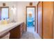Bathroom features a long vanity with storage and blue tiled shower room at 34211 Blanton Rd, Dade City, FL 33523