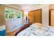 Bright bedroom featuring a cozy chair near a window and a classic wooden wardrobe at 34211 Blanton Rd, Dade City, FL 33523