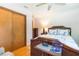 Bedroom with hardwood floors, queen bed, dresser, closet, and nightstand at 34211 Blanton Rd, Dade City, FL 33523