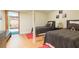 Comfortable bedroom offering two twin beds with wood floors and access to another room at 34211 Blanton Rd, Dade City, FL 33523