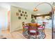 Dining area showcasing hardwood floors, a round wooden table, and seamless flow into the kitchen at 34211 Blanton Rd, Dade City, FL 33523