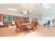 Bright dining area boasts a skylight, brick accent wall, chandelier, and hardwood floors at 34211 Blanton Rd, Dade City, FL 33523