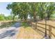 Tree-lined driveway with lamp post offers a grand entrance to this private estate at 34211 Blanton Rd, Dade City, FL 33523