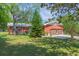 Exterior view of the home featuring a well-maintained lawn and two-car garage at 34211 Blanton Rd, Dade City, FL 33523