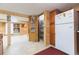 Kitchen and pantry area in a wood paneled basement at 34211 Blanton Rd, Dade City, FL 33523