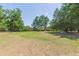 Large, grassy lot surrounded by mature trees, offering privacy and a serene setting at 34211 Blanton Rd, Dade City, FL 33523