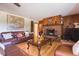 Inviting living room with brick fireplace, hardwood floors, and comfortable seating arrangement at 34211 Blanton Rd, Dade City, FL 33523
