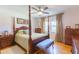 Bedroom with hardwood floors, four poster bed, ceiling fan, and natural light at 34211 Blanton Rd, Dade City, FL 33523