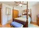 Bedroom with hardwood floors, four poster bed, ceiling fan, and closet at 34211 Blanton Rd, Dade City, FL 33523