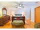Spacious primary bedroom boasts hardwood floors, a ceiling fan, and a decorative dresser at 34211 Blanton Rd, Dade City, FL 33523