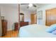 Bedroom with hardwood floors, four poster bed, closet, ceiling fan, and dresser at 34211 Blanton Rd, Dade City, FL 33523