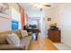 Home office with hardwood floors, sofa, desk, and storage, lit by a ceiling fan at 34211 Blanton Rd, Dade City, FL 33523