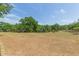 Rolling pasture featuring mature trees and grazing animals adds to the property's rural charm at 34211 Blanton Rd, Dade City, FL 33523