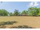 Expansive lush property, featuring verdant space and mature trees, with ranch-style home in the background at 34211 Blanton Rd, Dade City, FL 33523