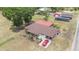 An aerial view of a cozy home with a red car in the driveway, and a large yard at 3515 Bell Farms Dr, Plant City, FL 33566