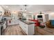 Open-concept kitchen with a central island, farmhouse sink, modern appliances, and seamless transition to the living area at 3515 Bell Farms Dr, Plant City, FL 33566