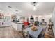 Open-concept living area flows into the kitchen and dining, with wood floors throughout at 3515 Bell Farms Dr, Plant City, FL 33566