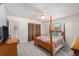 Bright bedroom featuring wood-look flooring, traditional furnishings, and a serene atmosphere with plenty of natural light at 3515 Bell Farms Dr, Plant City, FL 33566