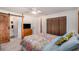 Cozy bedroom featuring a wooden four post bed, sliding barn door to the ensuite bathroom, and ample closet space at 3515 Bell Farms Dr, Plant City, FL 33566