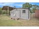 Charming shed with a small porch and decorative lattice detailing, adding character to the property at 3515 Bell Farms Dr, Plant City, FL 33566