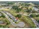 An aerial view of a residential neighborhood with well-maintained green spaces, lake and cul-de-sac at 36959 Highland Meadows Ct, Zephyrhills, FL 33542