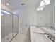 Modern bathroom with a large double vanity, frameless glass shower, and bright lighting at 36959 Highland Meadows Ct, Zephyrhills, FL 33542