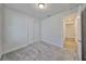 A bright, carpeted bedroom offers ample closet space and easy access to the adjacent hallway at 36959 Highland Meadows Ct, Zephyrhills, FL 33542