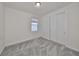 A well-lit bedroom features neutral carpeting, a window, and a closet with bi-fold doors at 36959 Highland Meadows Ct, Zephyrhills, FL 33542